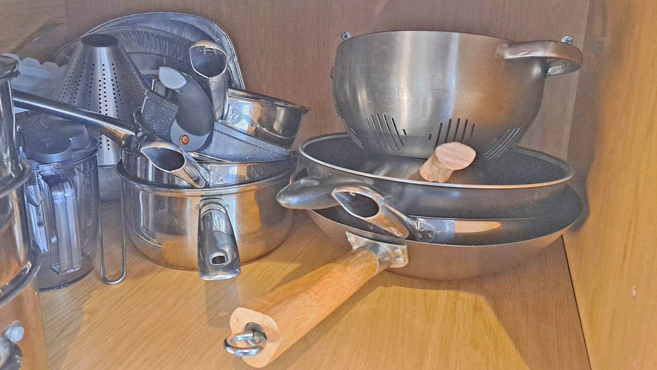 Cluttered pots in cupboard