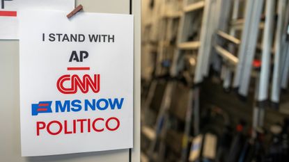 A sign in support of AP, CNN, MS NOW, and Politico near the James S. Brady Press Briefing Room of the White House.