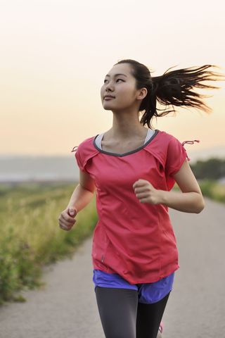 A woman running at sunset