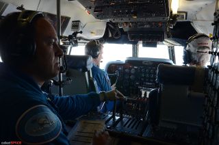 NASA astronaut Greg C. “Ray-J” Johnson (left) and NASA pilot Dick Clark seen at the controls of the Super Guppy during its flight between air bases in California, June 28, 2012. Seated behind them is David Elliott, flight engineer.