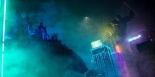 Kong hangs off the top of a building ready to attack Godzilla in Godzilla vs. Kong.