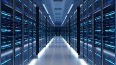 Data center server room with racks pictured on either side with walkway down the middle. 