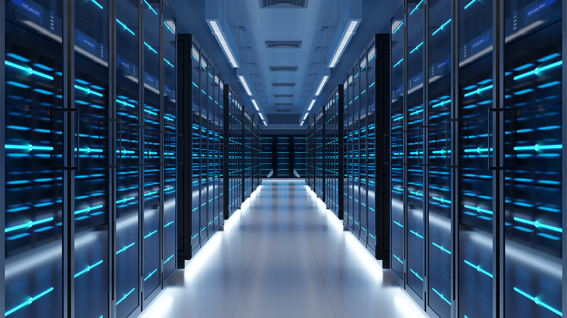 Data center server room with racks pictured on either side with walkway down the middle. 