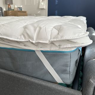 The Silentnight Airmax mattress topper strapped onto the corner of a mattress