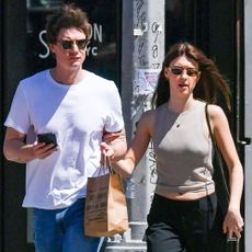 Daisy Edgar-Jones wears black trousers with mary janes.