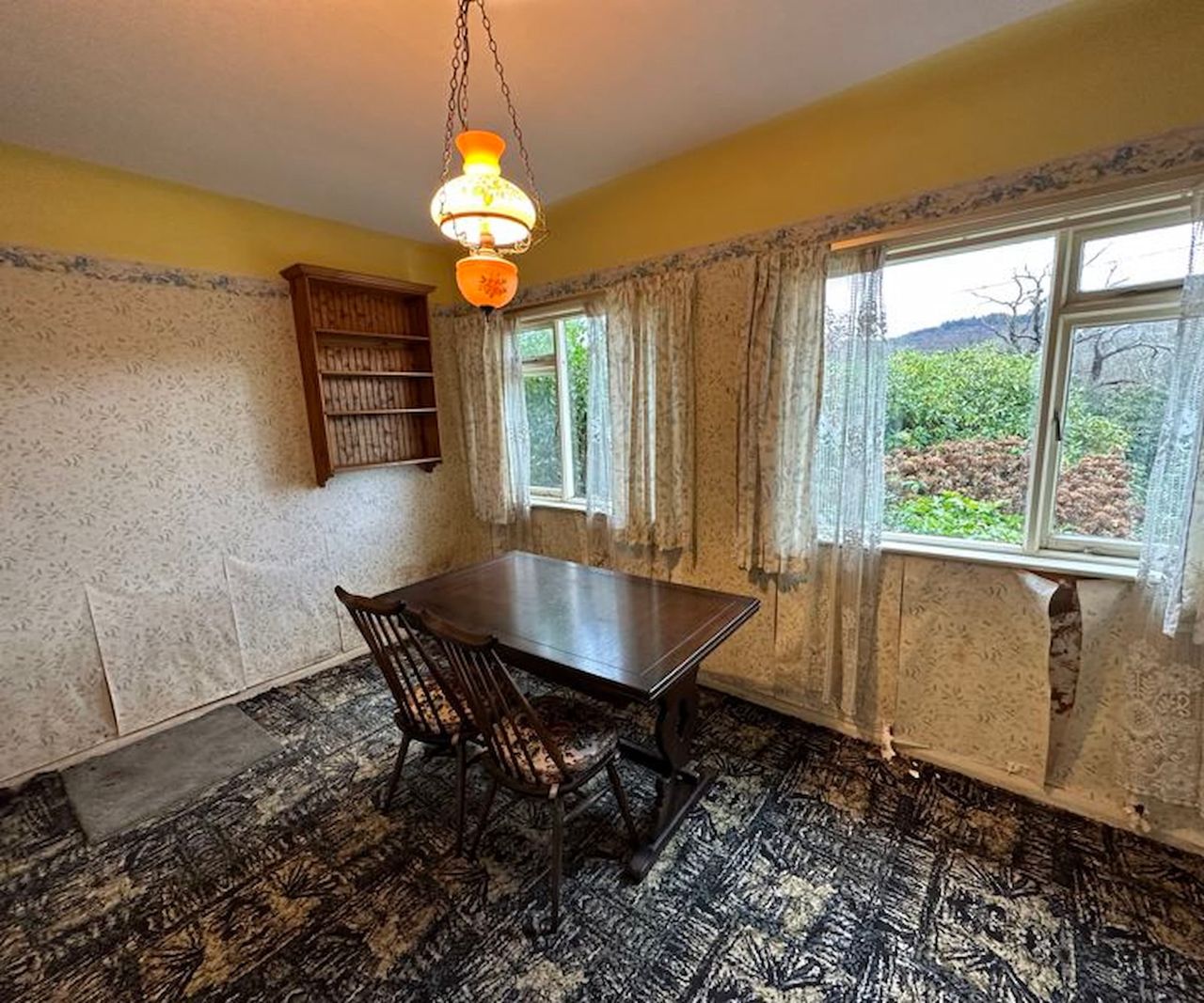 Peeling wallpaper in an old fashioned dining room