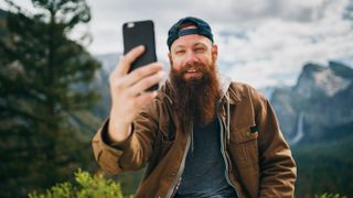 Cool bearded man taking selfie phot