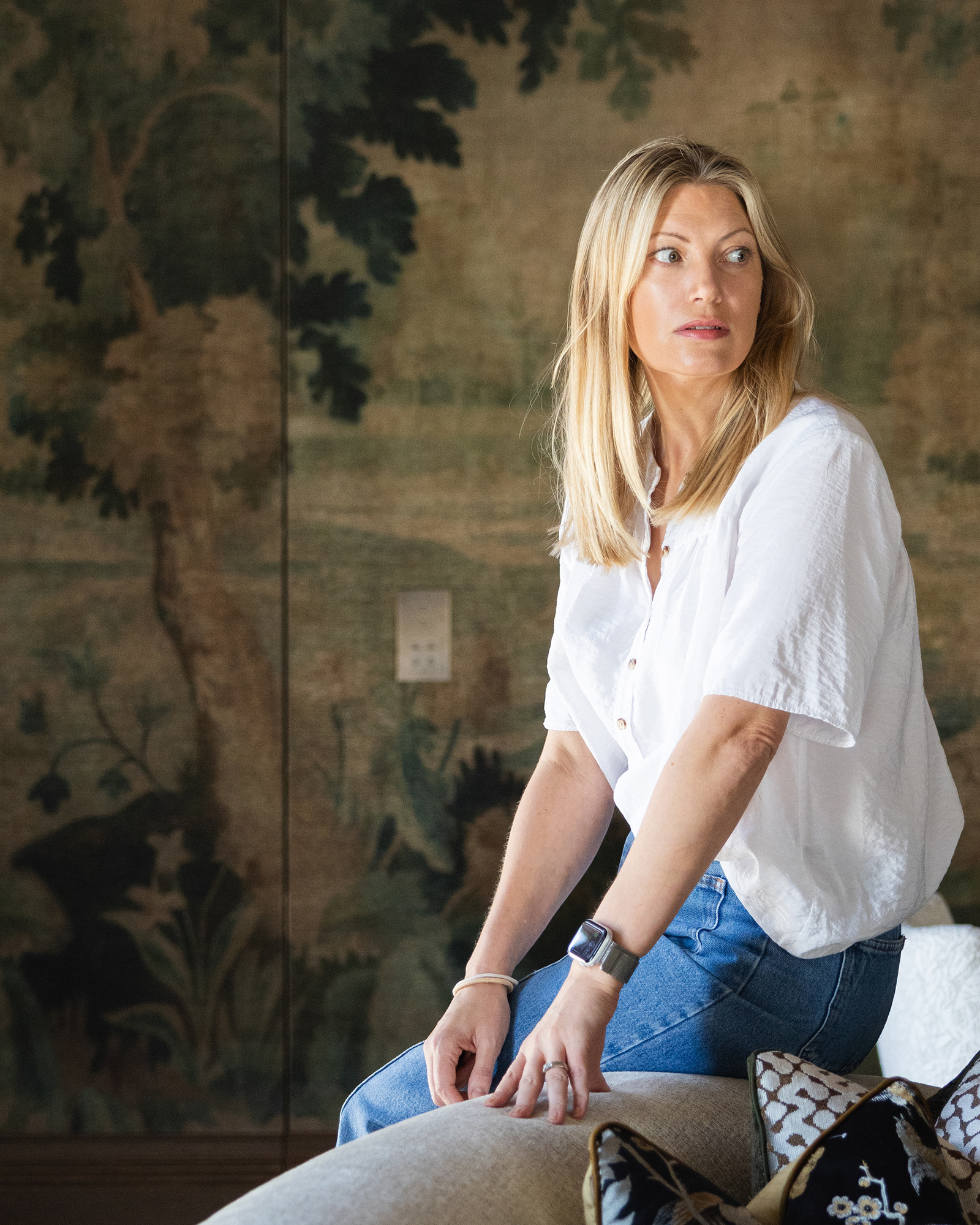Portia Fox sat on the back of a grey sofa