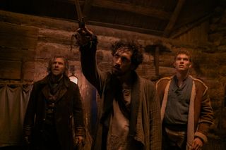 wheel of time episode 4: mat pointing dagger at fade with rand and thom behind him