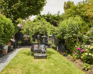 A small garden with lawn area and outdoor seating