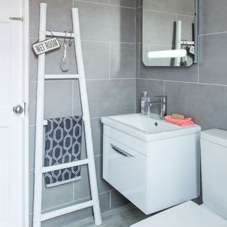bathroom with white door and tiled walls
