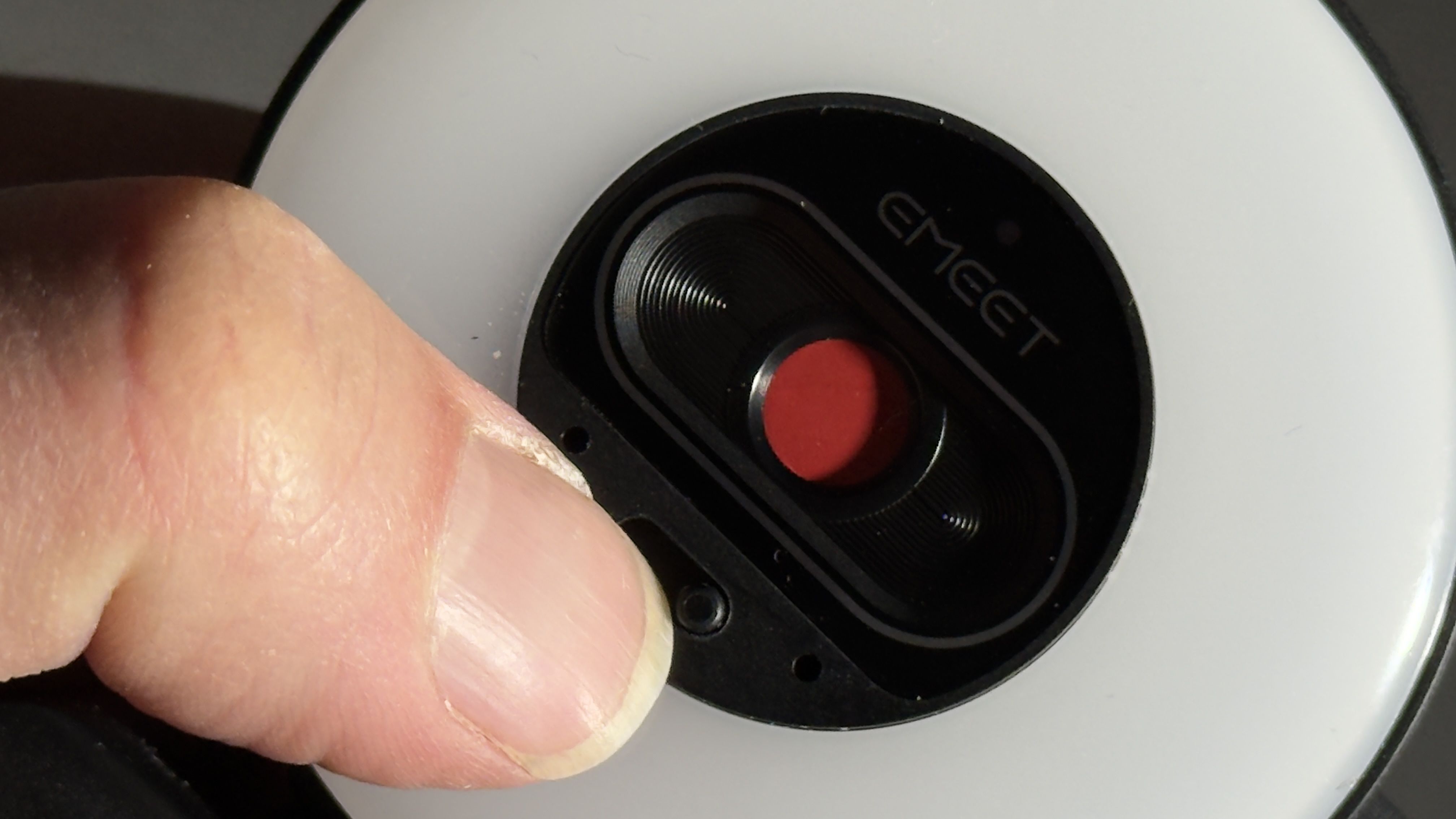 Close-up of the EMEET webcam with its red privacy shutter covering the lens.