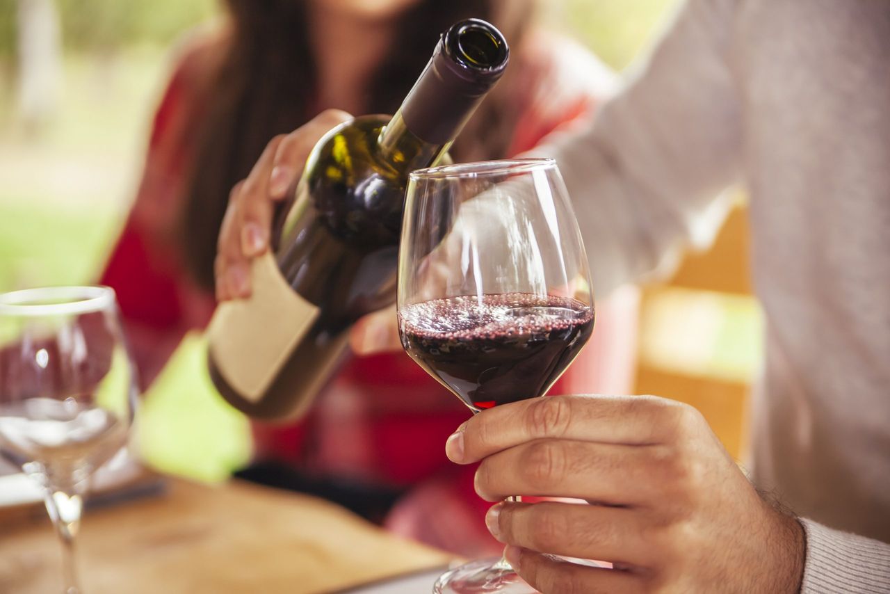 Man pouring a glass of red wine