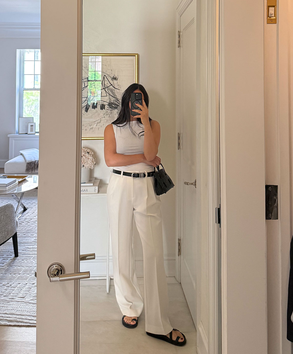 @nicoleakhtarzad taking a mirror outfit selfie and wearing all white.
