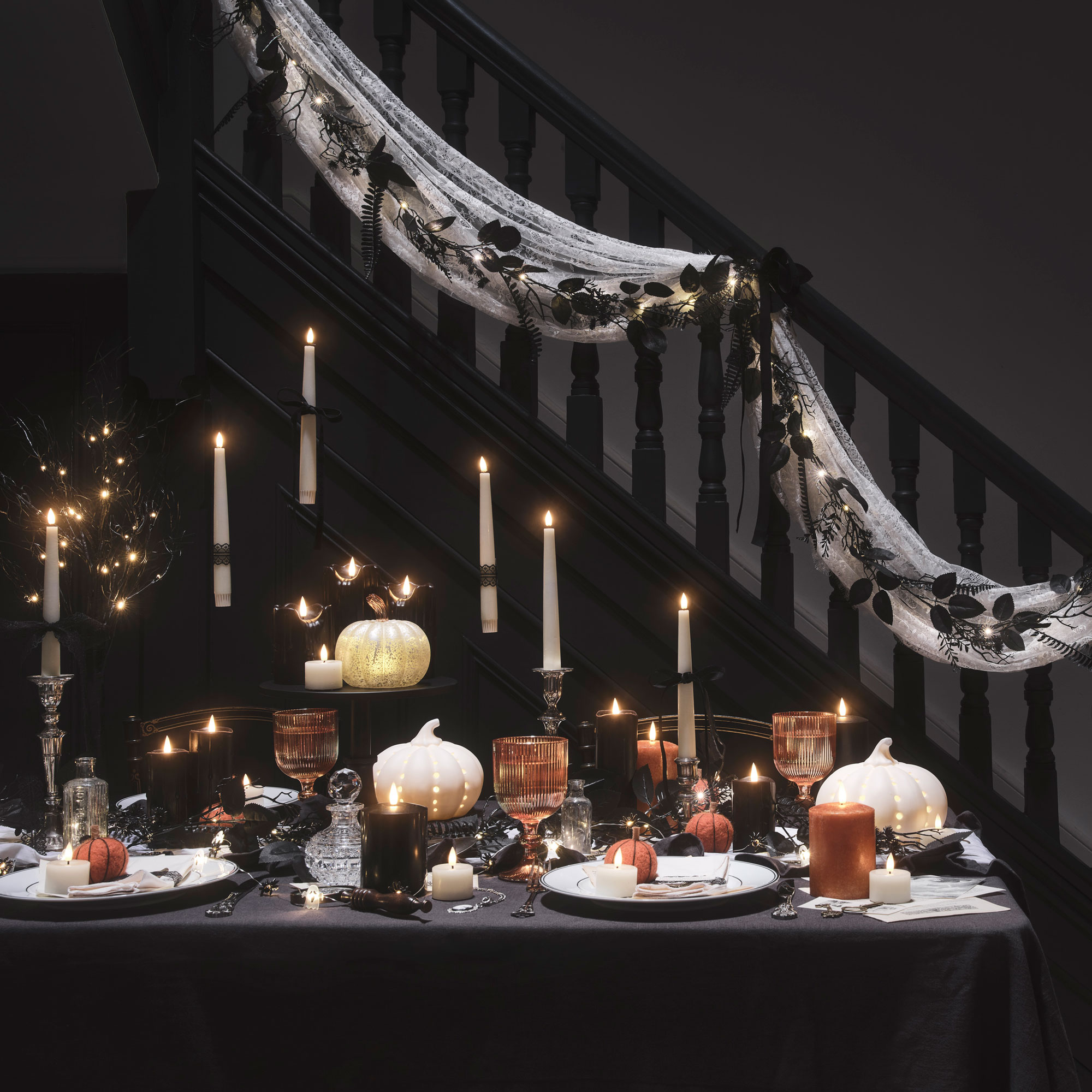 Black table cloth with varied candle heights