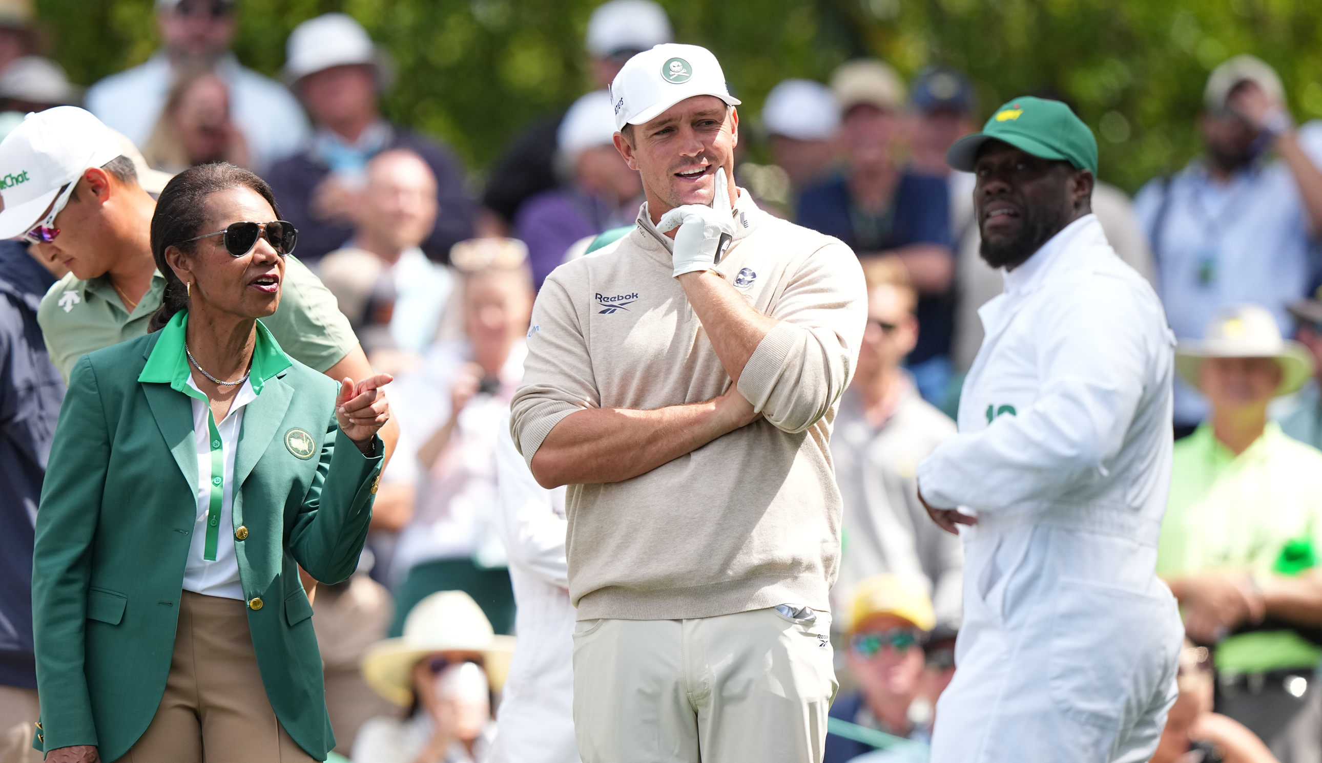Bryson DeChambeau, Actor/Comedian Kevin Hart and Former United States Secretary of State Condoleezza Rice look on during the Par 3 Contest prior to the Masters Tournament at Augusta National. Augusta