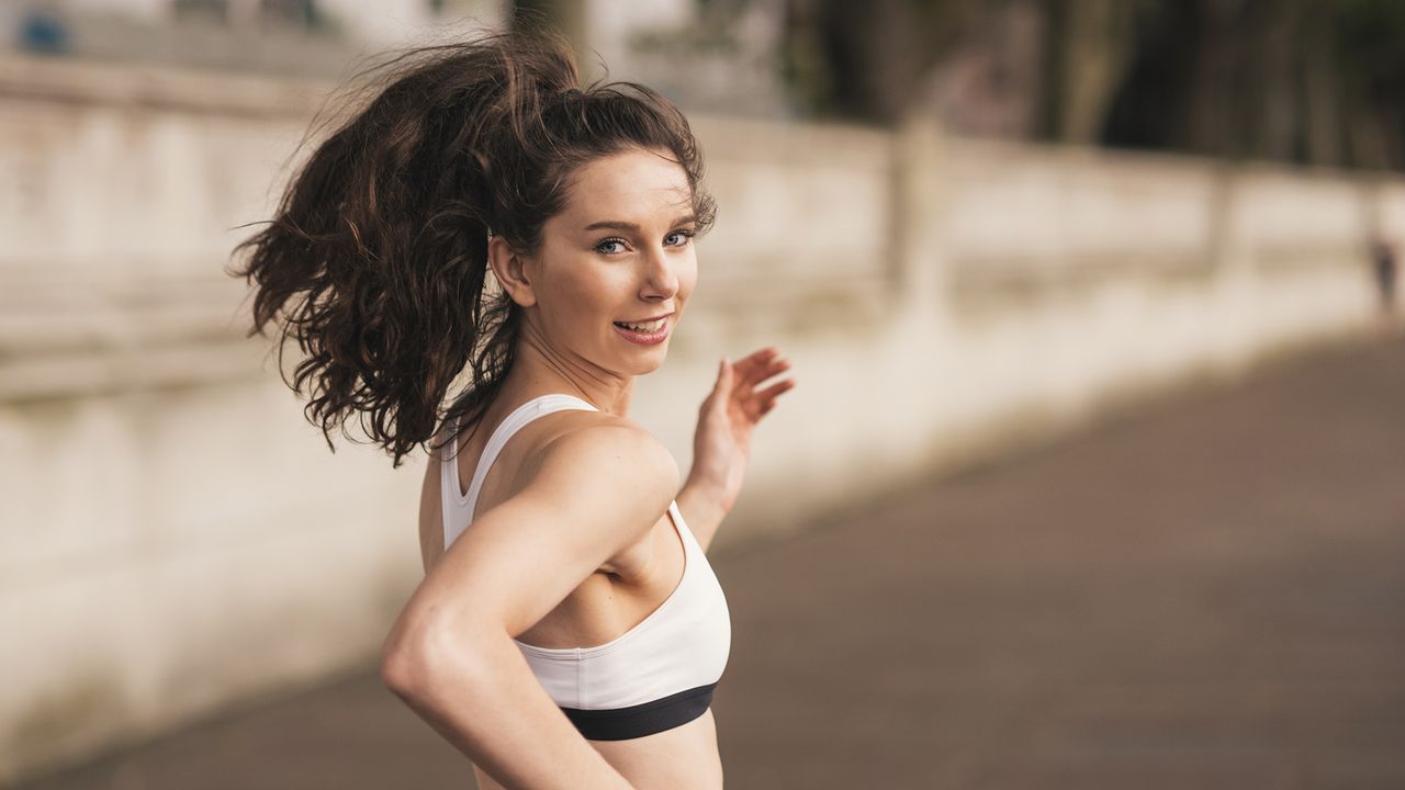 Female runner looking over her shoulder whilst running