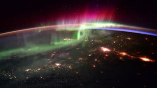 A photograph of rainbow pillars of light from an aurora over Canada