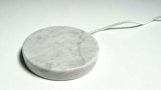 The Einova Charging Stone on a white desk