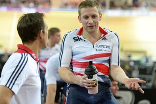 Jason Kenny goes over the event with sprint coach Justin Grace while warming down