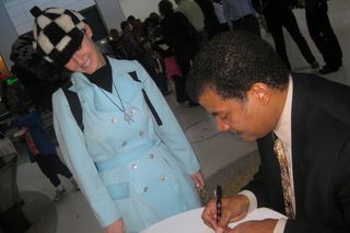 Neil deGrasse Tyson signing an autograph, just like any other celeb.