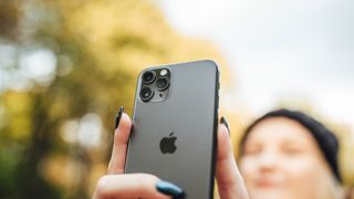 An iPhone being used to take a selfie, demonstrating how to mirror the front camera on iPhone