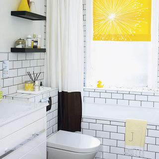 Bathroom with white metro tiles and yellow window blind