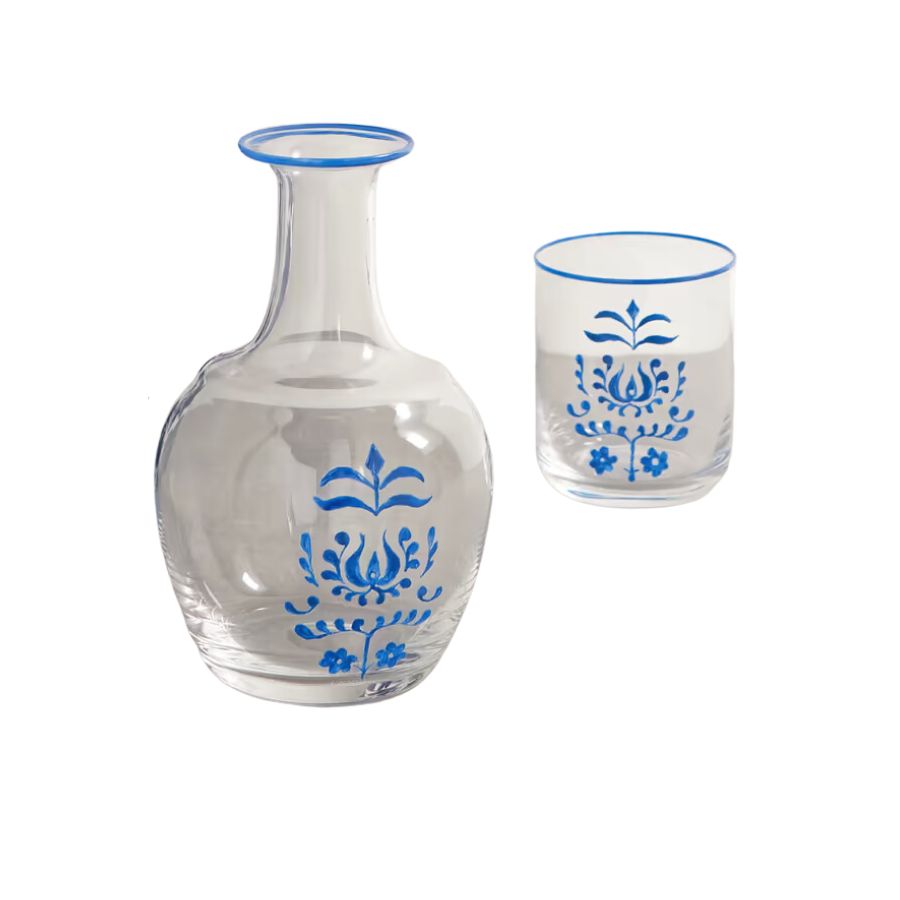 A glass decanter with blue rim