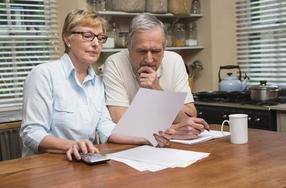 Senior couple working out their bills