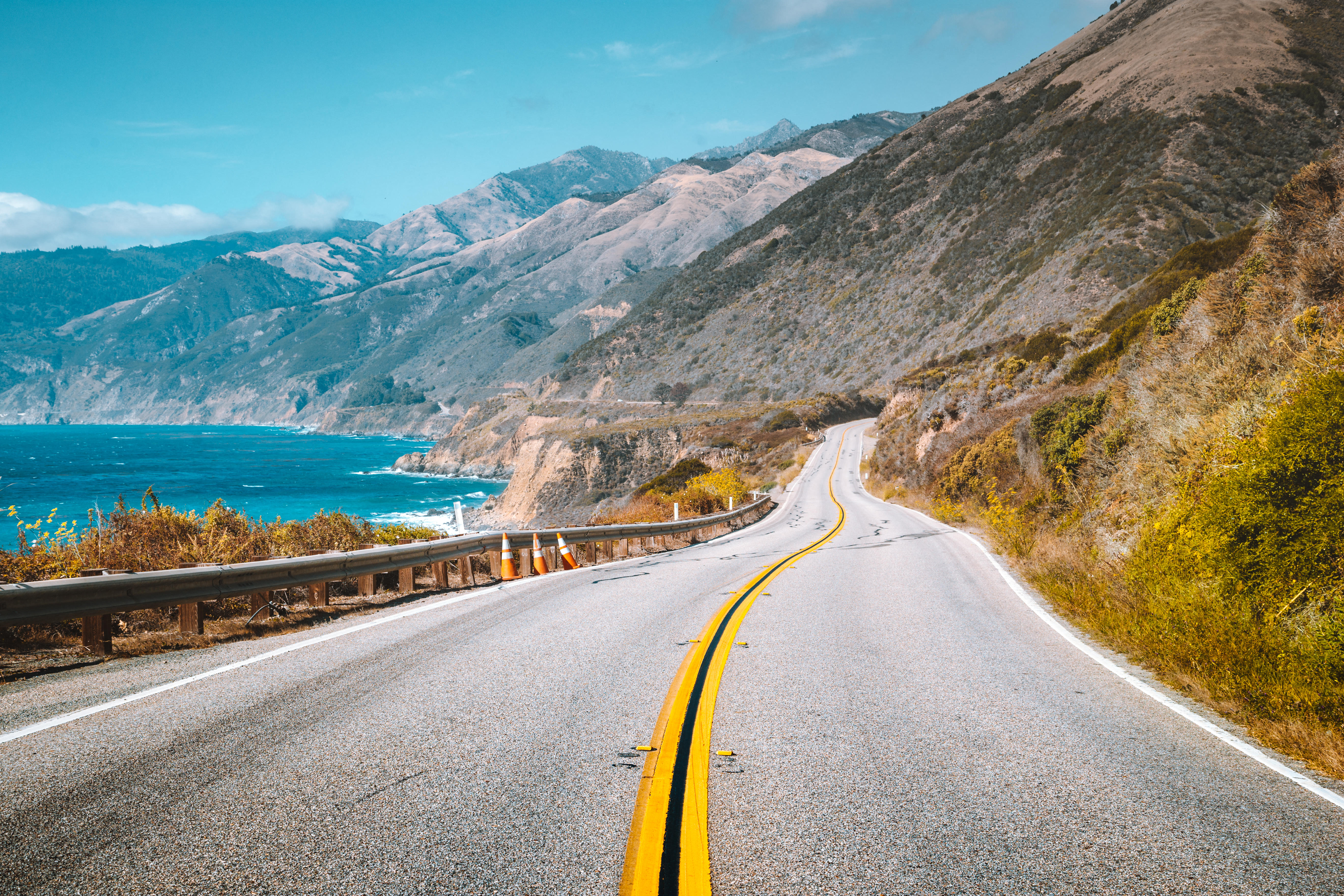 Scenic view of famous Highway 1 with the rugged coastline of Big Sur in beautiful golden evening light at sunset in summer, California Central Coast