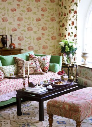 Floral themed living room with coffee table, candle sticks and flowers