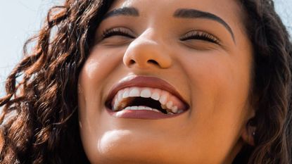 Woman smiling wide with clean white teeth