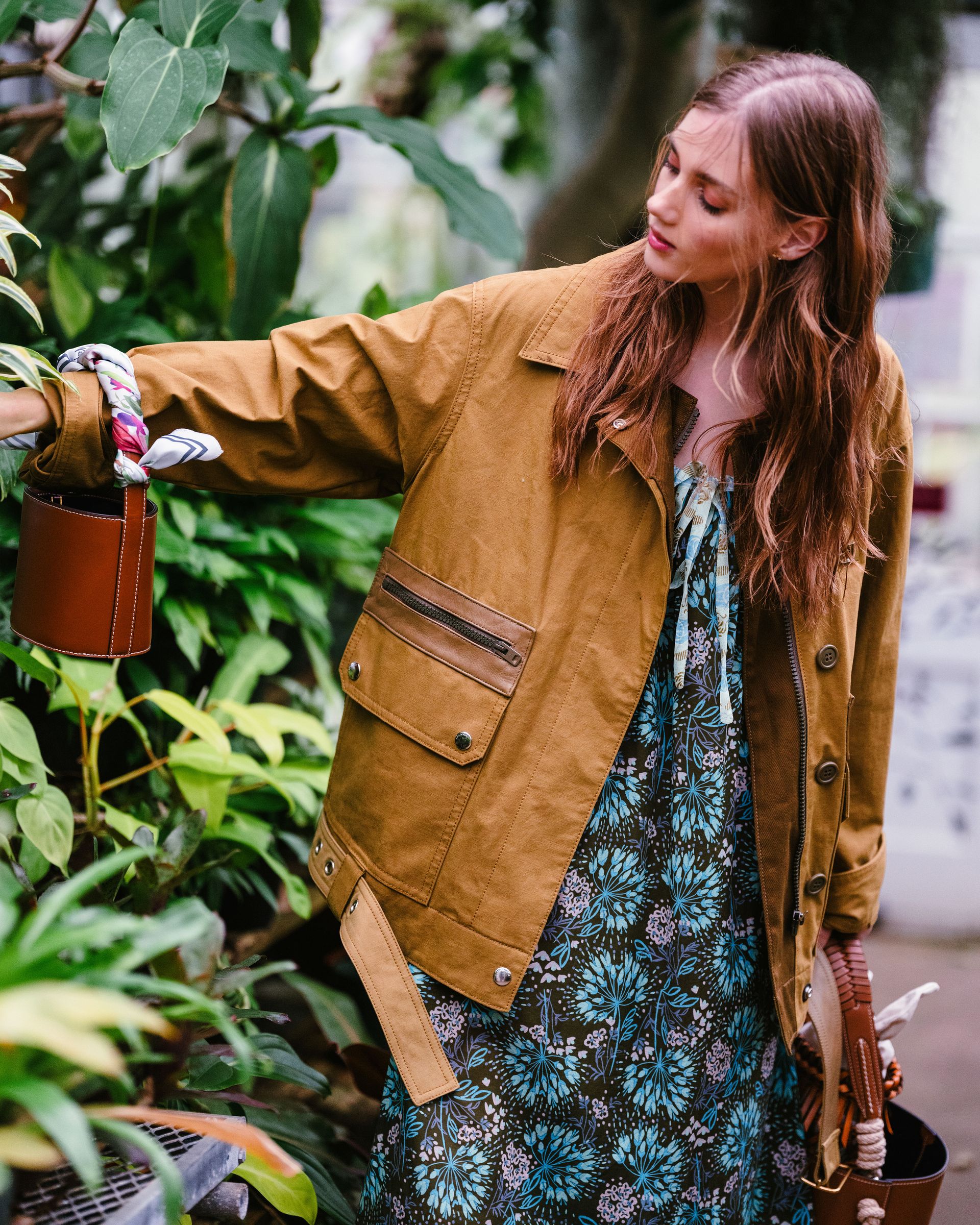woman in floral dress and tan utility jacket