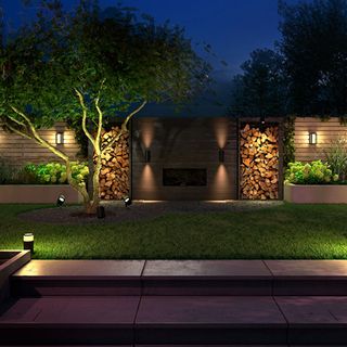 landscaped garden at night with a variety of garden lights brightening up the space