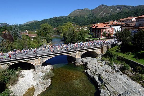 The peloton passes over one of the many rivers of this area of Spain