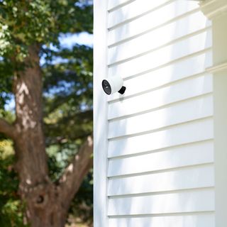 House with white walls and smart outdoor security cameras