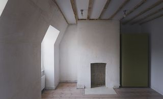 Image of a the top floor room showing sloped ceilings with wooden beams