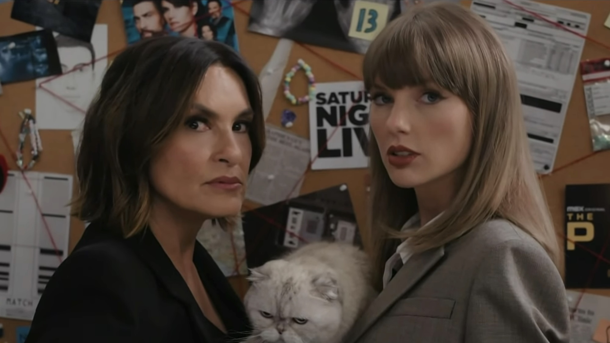 Olivia Benson and Taylor Swift holding cat in front of bulletin board in SVU sketch during 2026 Emmy Awards