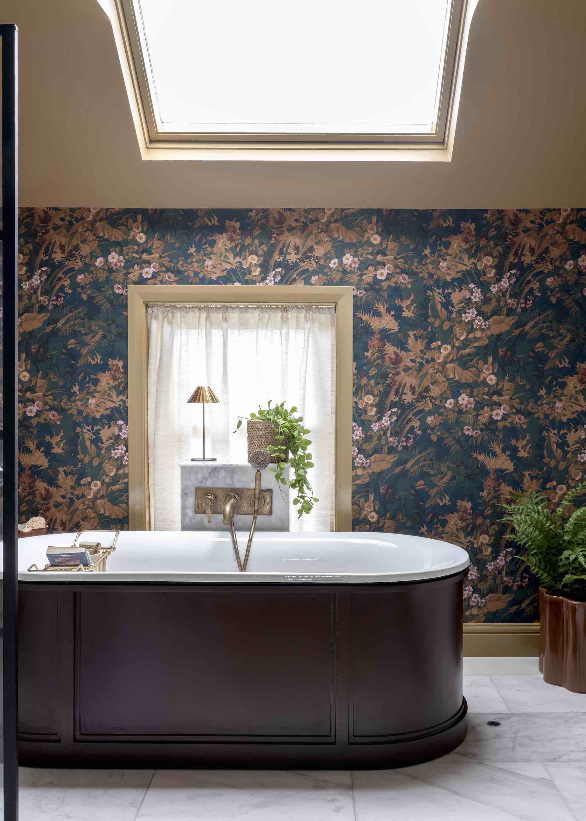 bathroom with floral wallpaper and a freestanding bath