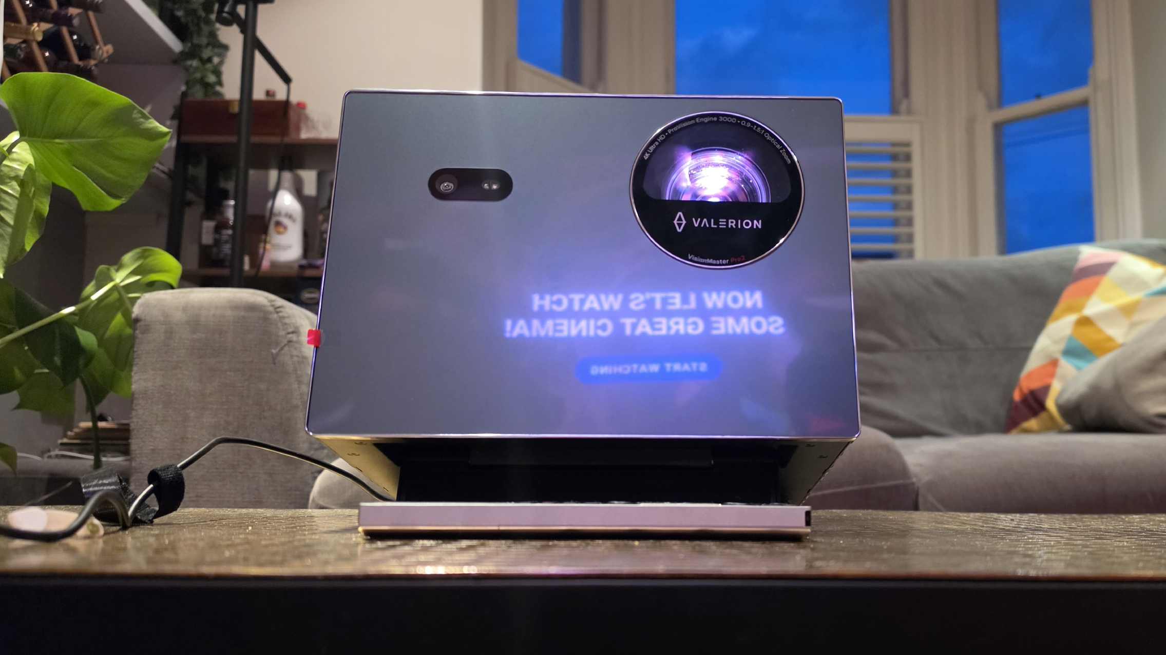 The Valerion VisionMaster 2 Pro on a table, with Mubi's opening screen reflected onto its body.