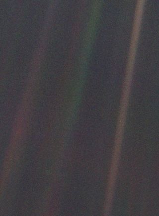 The Pale Blue Dot image is a part of the first portrait ever made of our solar system from afar, taken by Voyager 1. Voyager acquired 60 frames for a mosaic of the solar system from more than 4 billion miles from Earth and about 32 degrees above the ecliptic — the plane in which most of the planets orbit. Earth is just below and right of center, smack in the middle of one of the scattered light rays resulting from taking the image so close to the sun.