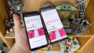 Google Pixel 8a and Google Pixel 6 Pro held together with Pixel 8a review on screen