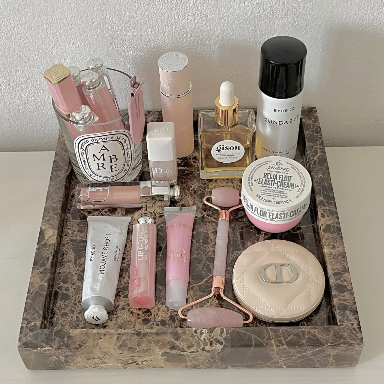 Photo of makeup and skincare products on a marble tray