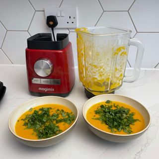 Blended carrot soup in bowls in front of Magmix Power Blender