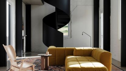 A living room staircase with yellow sofa