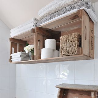 Towel with white tiles and wooden box