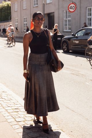 woman wearing tank top and skirt