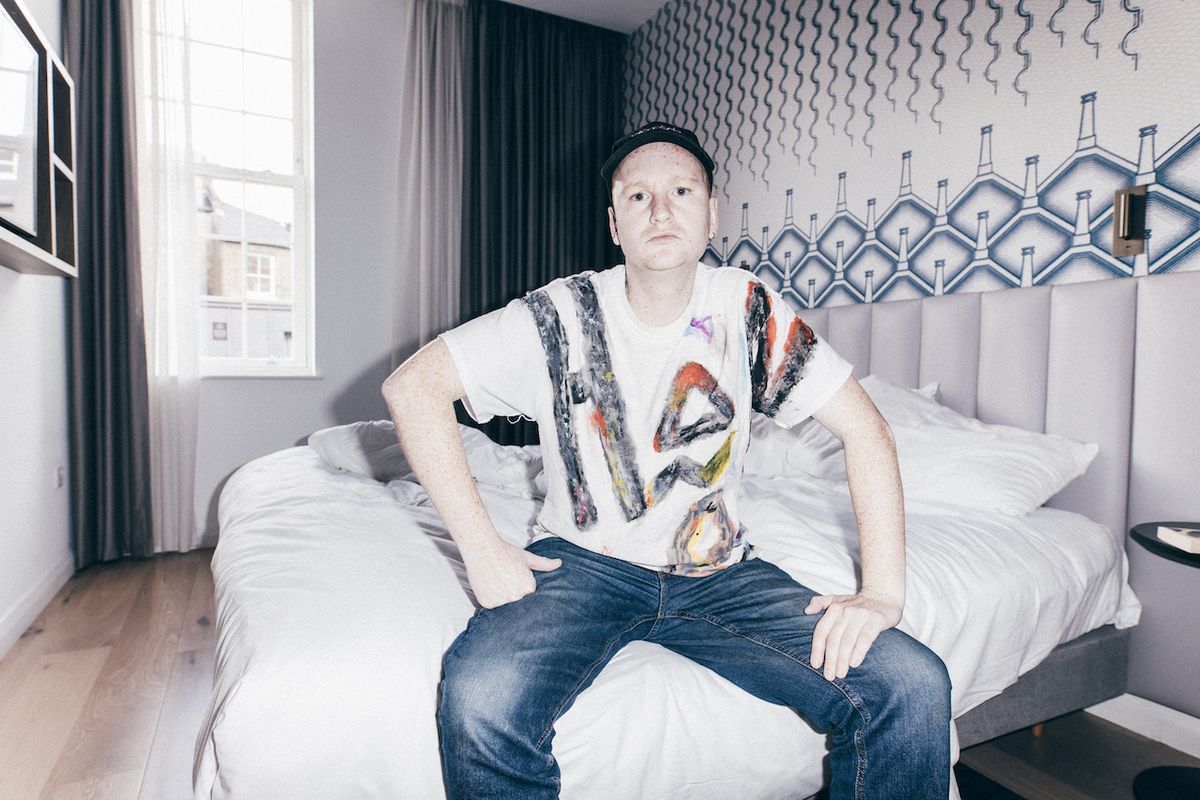Members of Amyl and the sniffers sat on a bed