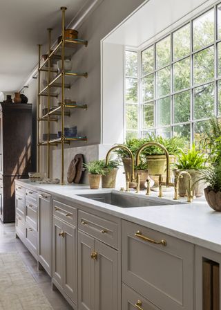 beige and gold kitchen with open shelving