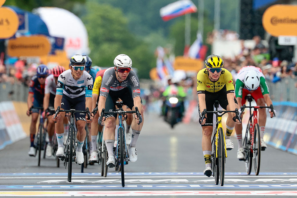 Alpecin-Deceuninck's Australian rider Kaden Alexander Groves (3rd R) crosses the finish line placed second next to Team Visma-Lease a Bike's Dutch rider Olav Kooij (2nd R) placed third after the 14th stage of the 108th Giro d'Italia cycling race of 195kms from Treviso in Italy to Nova Gorica in Slovenia on May 24, 2025. (Photo by Luca Bettini / AFP)